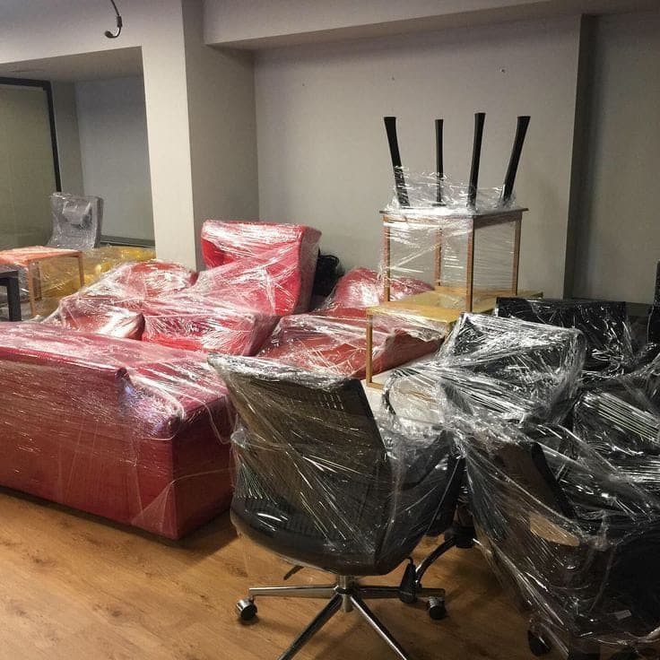 Sofas, chairs and tables wrapped in protective film by the Vegas Moving crew, ready for a household relocation